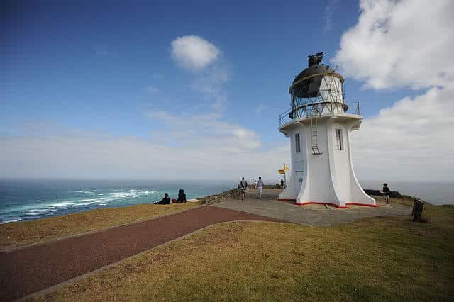 Image of a sign found at Cape Reinga pointing to different places around the world with the distance