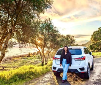 Image of Camille next to a GO Rentals vehicle