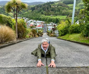 Man playfully posing on a steep street