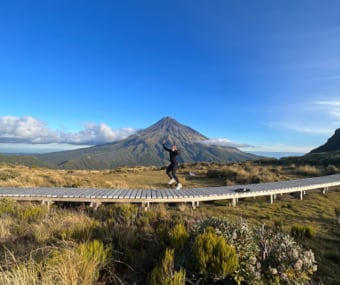 Image of Jade jumping in front of the mountain