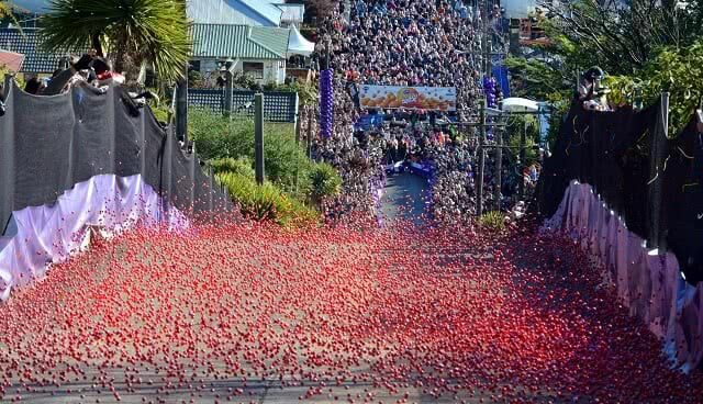 Thousands of Cadbury Jaffas hurtle down Baldwin Street - part of the Dunedin Cadbury Chocolate Carnival