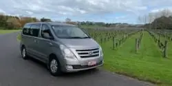 Image of a Hyundai iMax People Carrier parked up at a New Zealand vineyard with rows of vines in the background